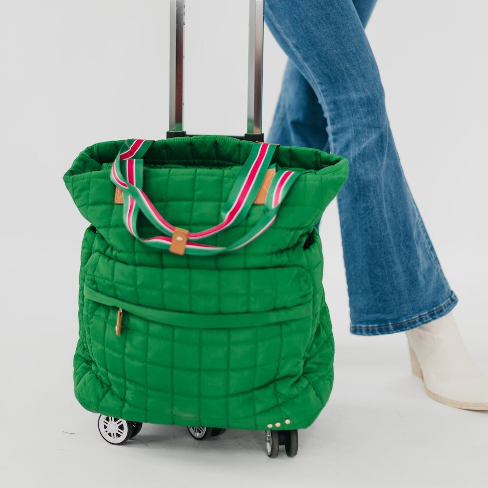 Quilted emerald tote roller bag with striped trim and front pocket, rolling wheels