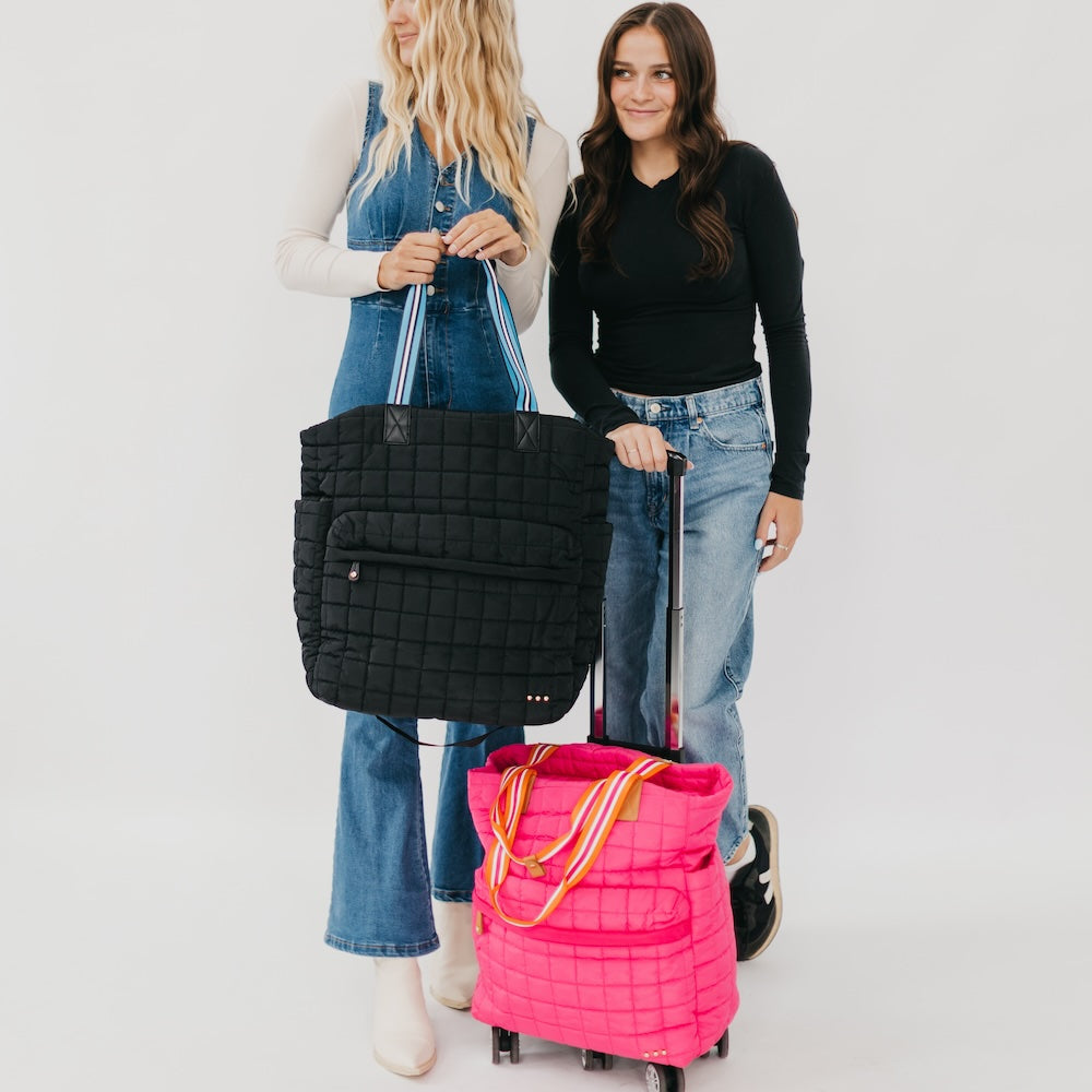 Black and pink quilted tote roller bags on wheels, each with zip top