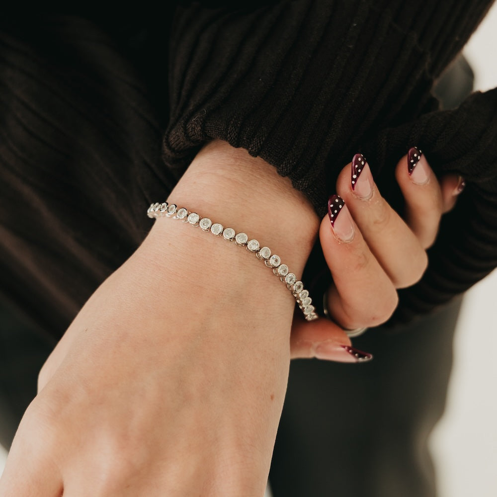 Tennis bracelet with round clear stones on a silver setting