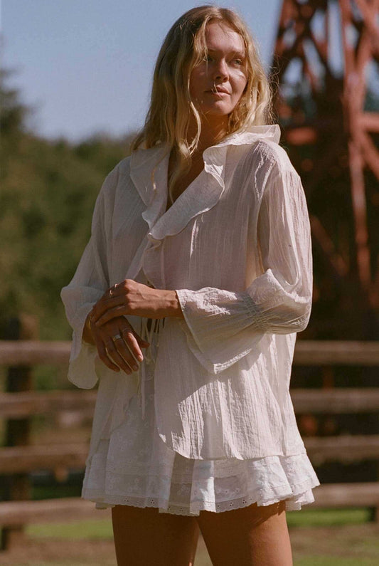 Ivory ruffle blouse top with long puff sleeves and tiered shoulder detail