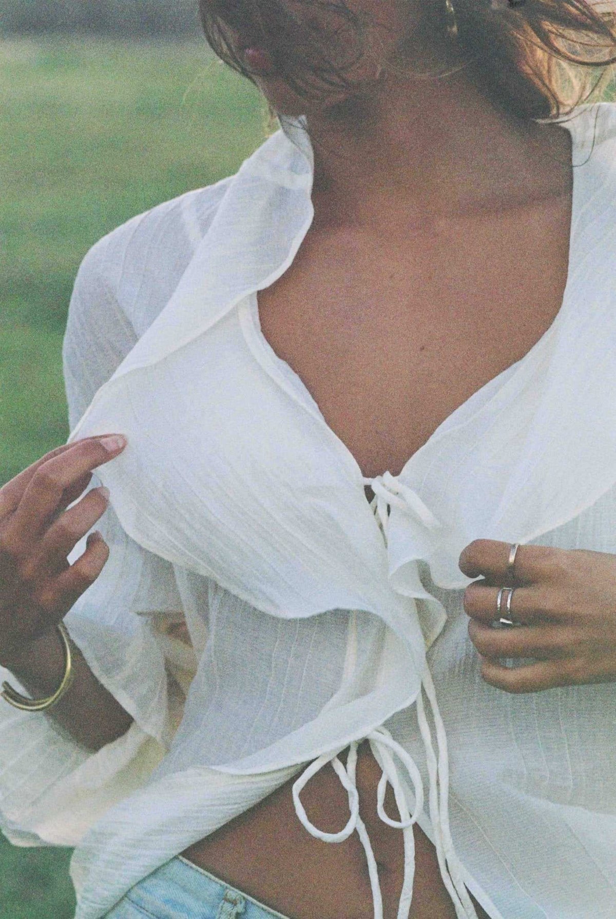 Ivory V-neck ruffle top with tie-front strings and layered neckline
