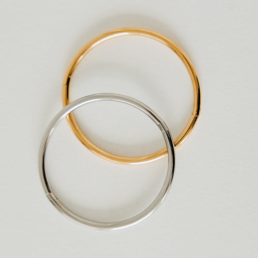 Gold and silver bangle bracelets, overlapping round cuffs with smooth finish