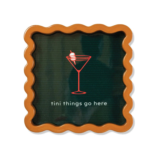 Lacquer tray with scalloped orange rim and dark green surface, martini logo and text