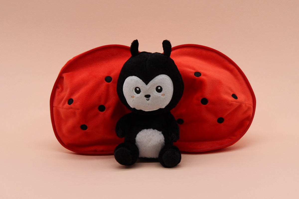 Red tomato-shaped plush with black ladybug face and wings, dot pattern on shell