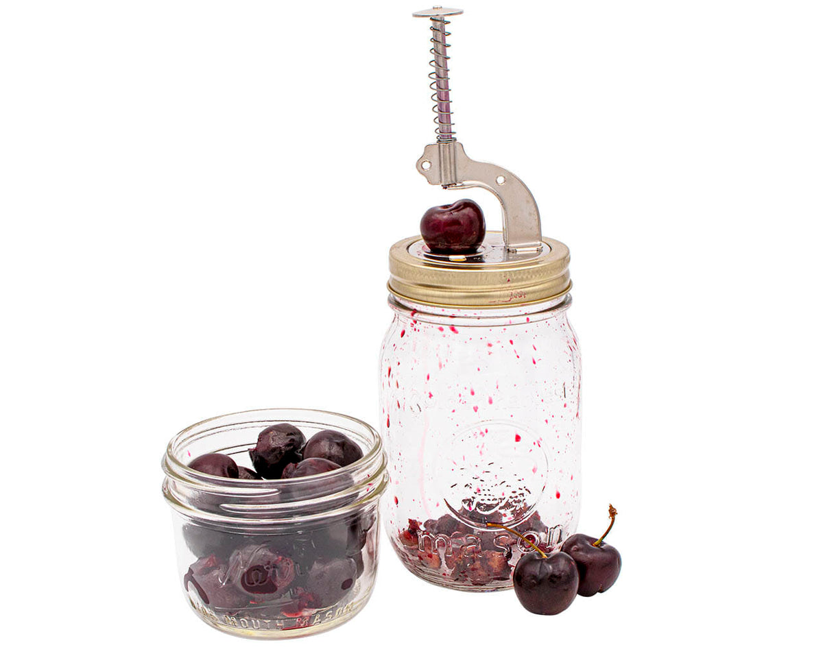 Mason jar cherry pitter with push-button handle, chrome and bronze metal frame