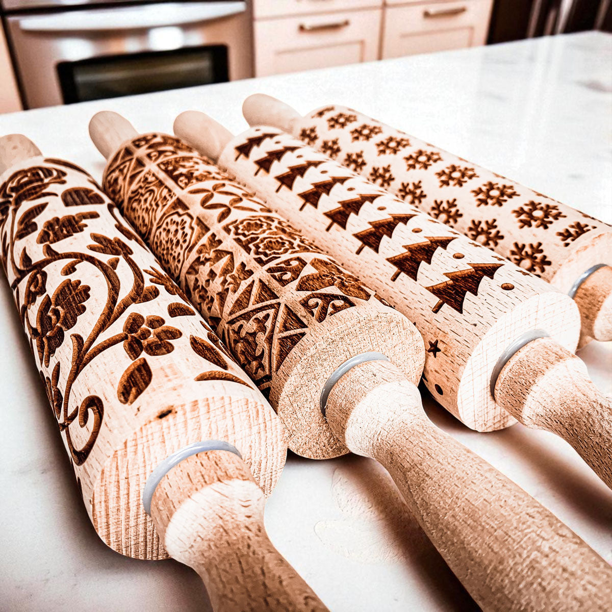 Christmas rolling pin set with embossed reindeer, tree and star patterns on wood barrels