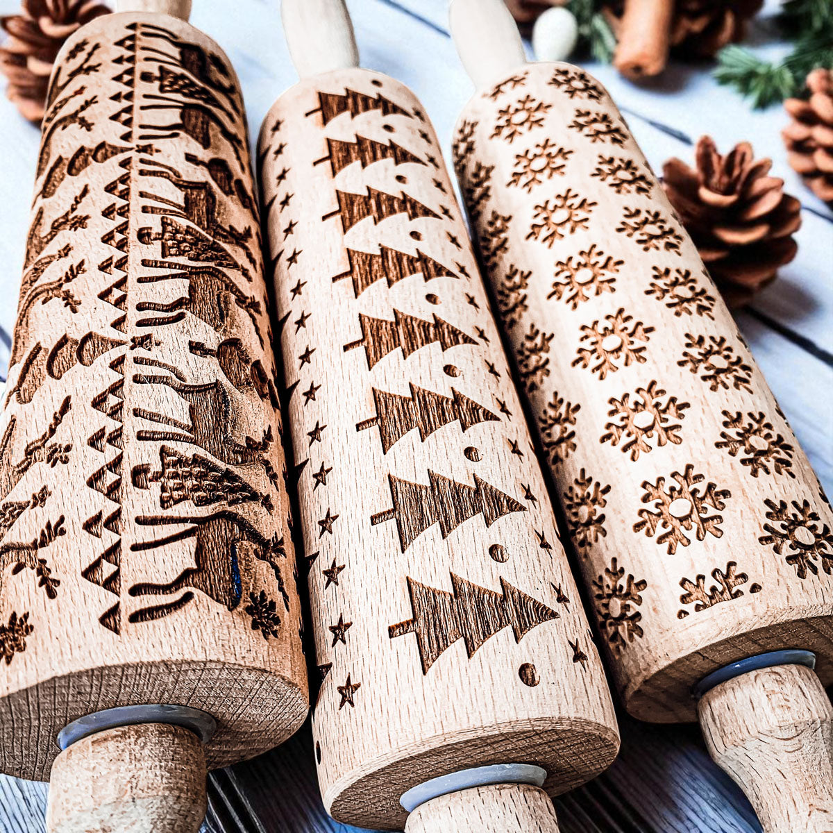 Close-up of Christmas rolling pin barrels with embossed snowflake and tree patterns