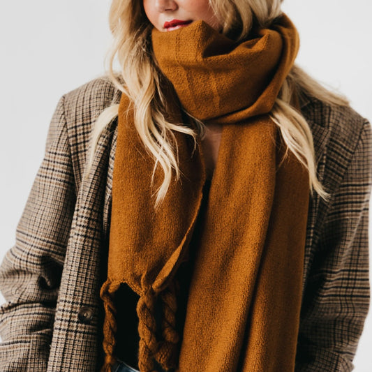 Twyla twisted tassel scarf in caramel brown, draped around the neck with tassels