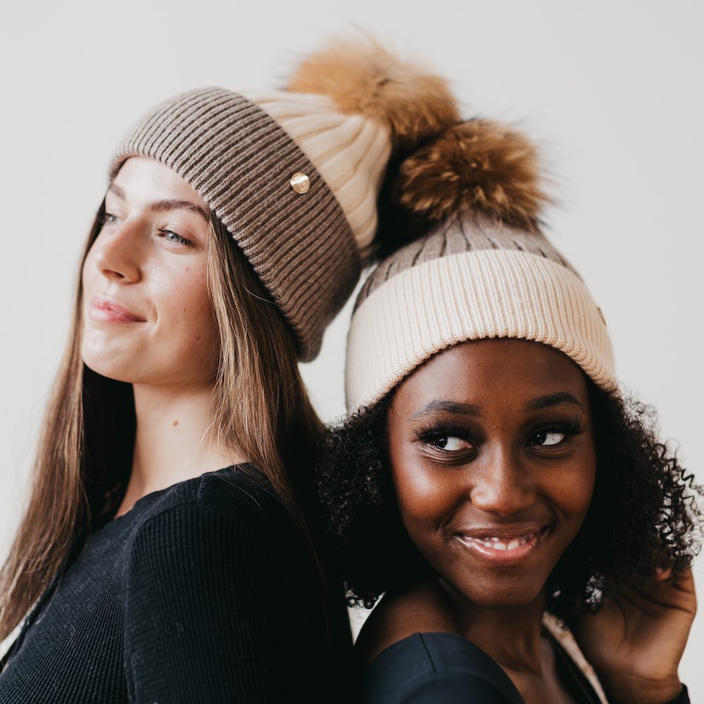 Two-tone angora knit beanie with tan fur pom; light cream ribbed cuff