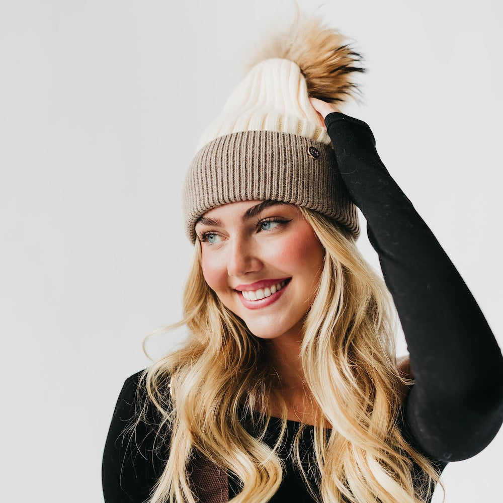 Two-tone angora knit beanie with tan fur pom and ribbed cuff, light body