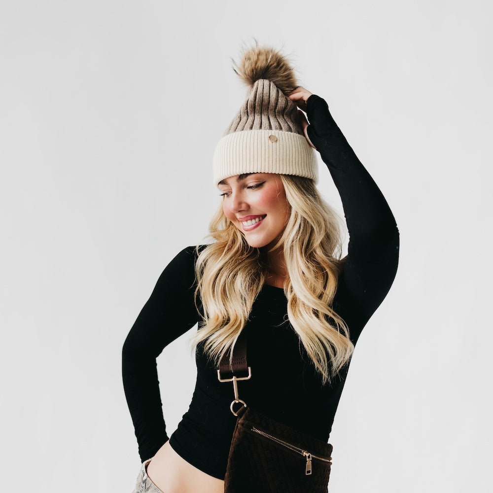 Two-tone angora knit beanie with tan fur pom, light knit body and ribbed cuff