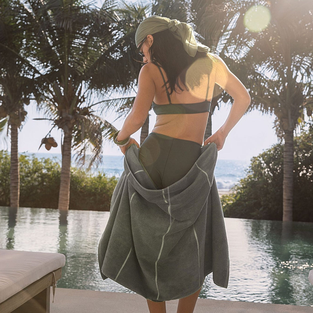 Sage-green cotton towel wrap with white stripe, worn at the waist