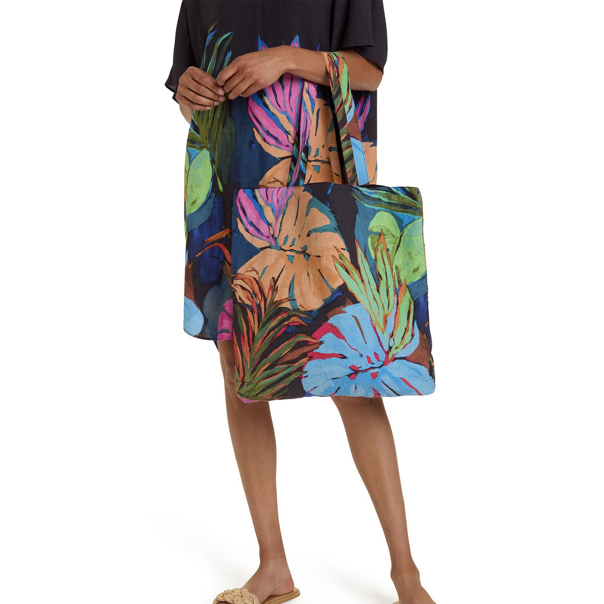 Colorful canvas tote bag with tropical leaf and flower print, top handles