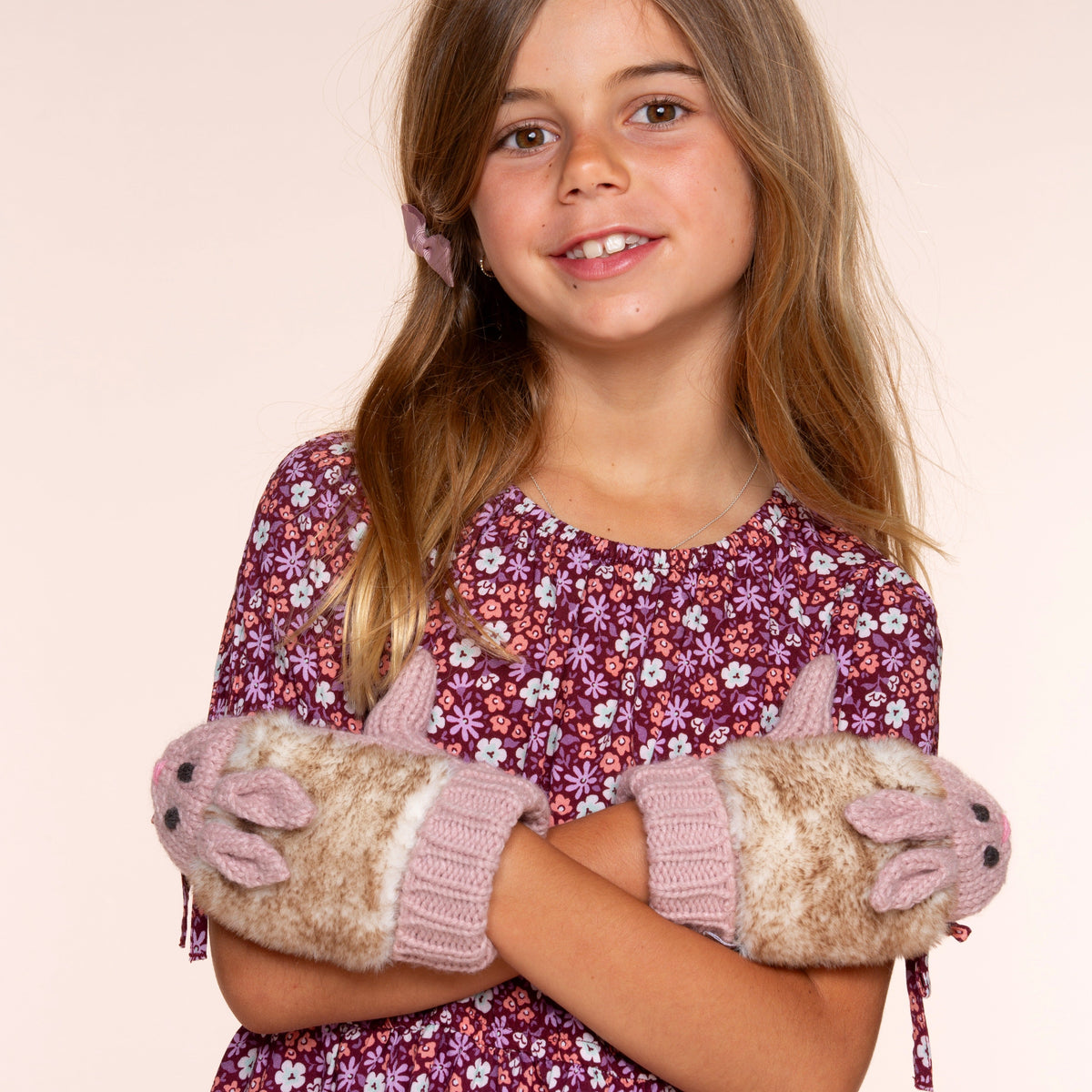 Fleece-lined rabbit mittens with pink knit cuffs, worn on a child