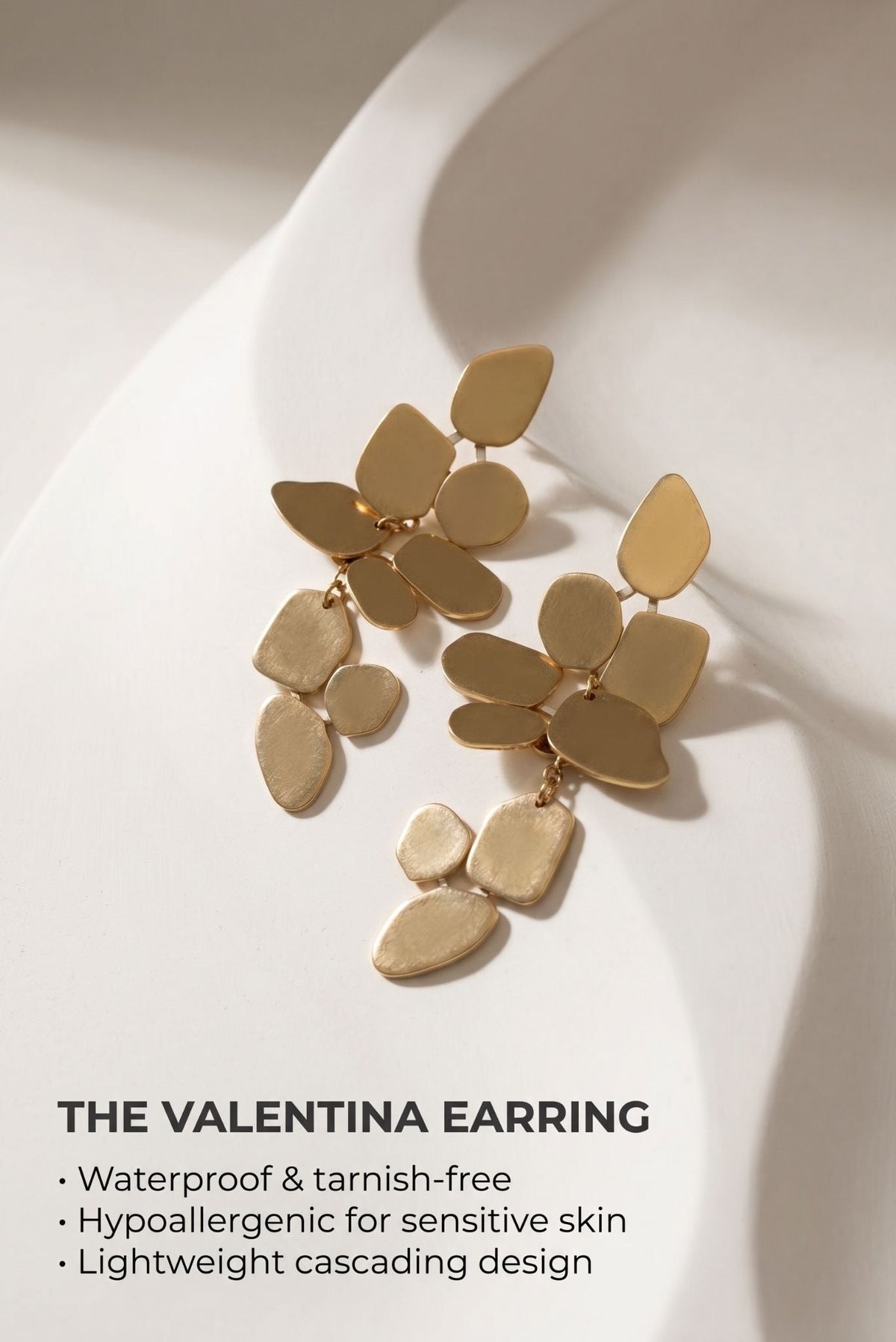 Gold-tone layered leaf-disc statement earrings with small dangling drops