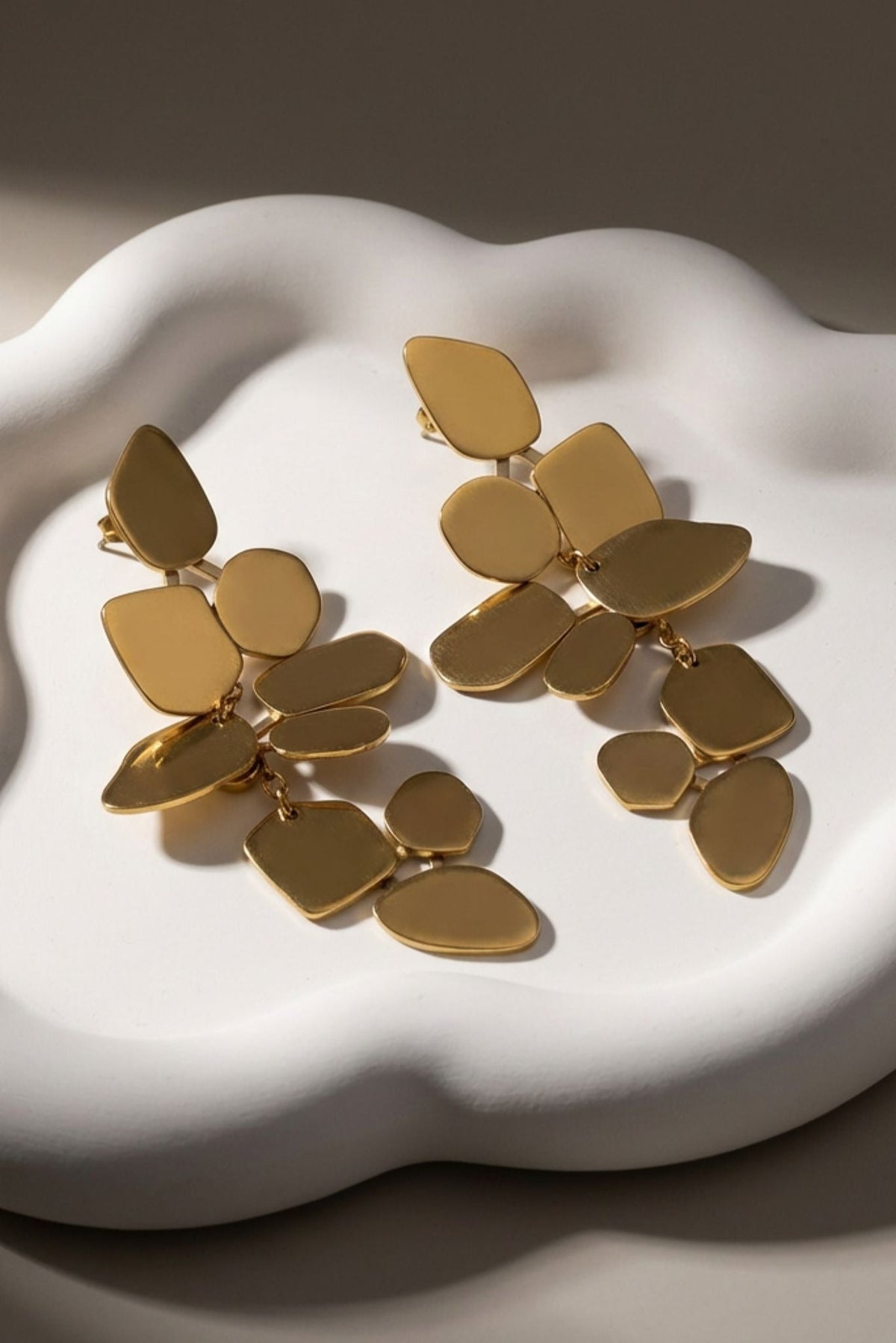 Gold-tone multi-disc statement dangle earrings with layered leaf shapes