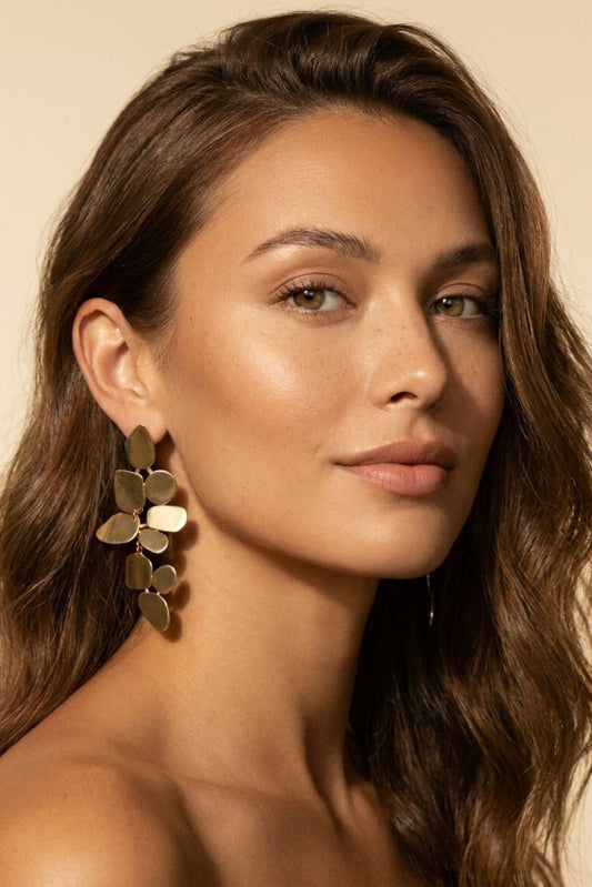 Gold-tone dangle earrings with overlapping leaf-shaped discs, statement drop style