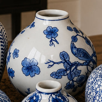Blue-and-white ceramic vase with floral and bird motifs, close-up view