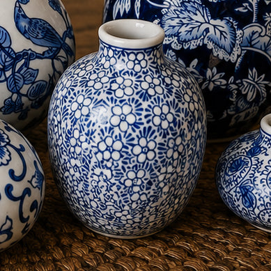 Blue-and-white ceramic vase with floral texture, close-up on wood