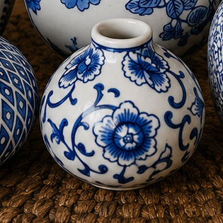 Blue and white ceramic vase with floral pattern and wide rounded body