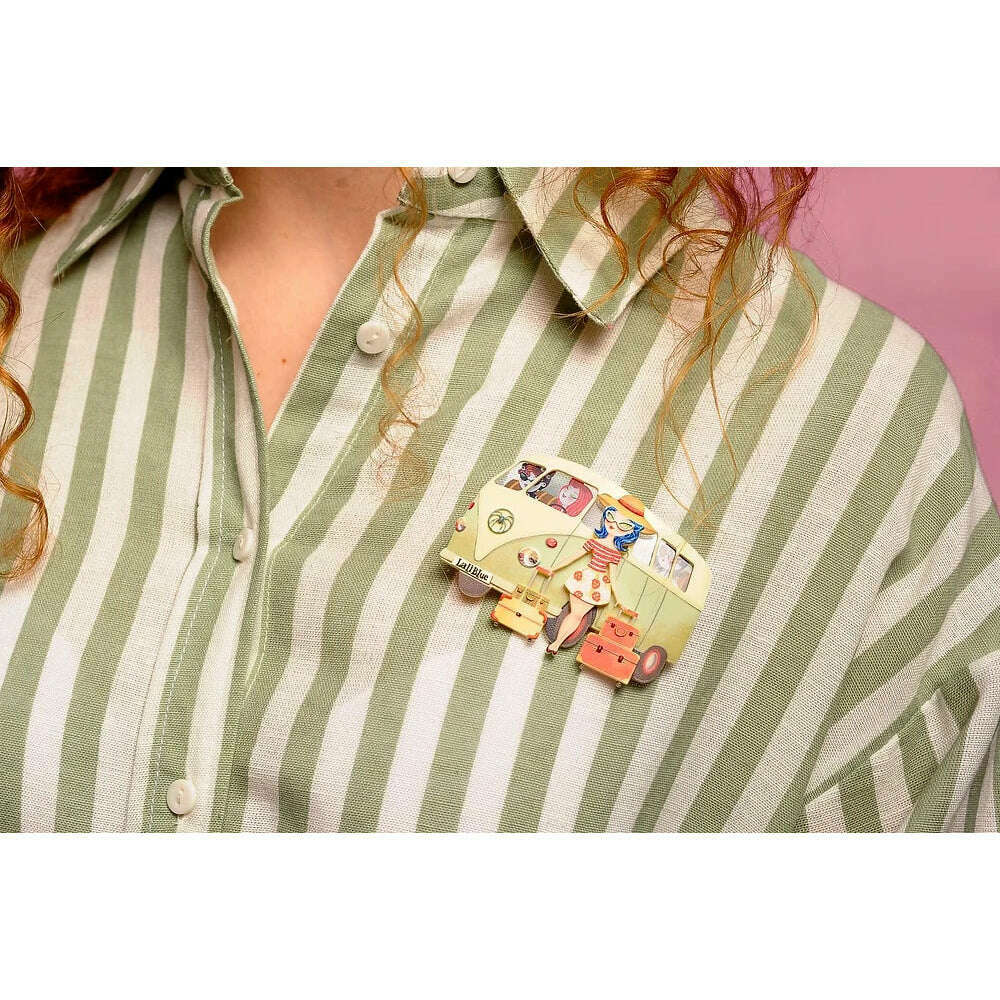 Vintage van brooch pinned to green-and-white striped shirt