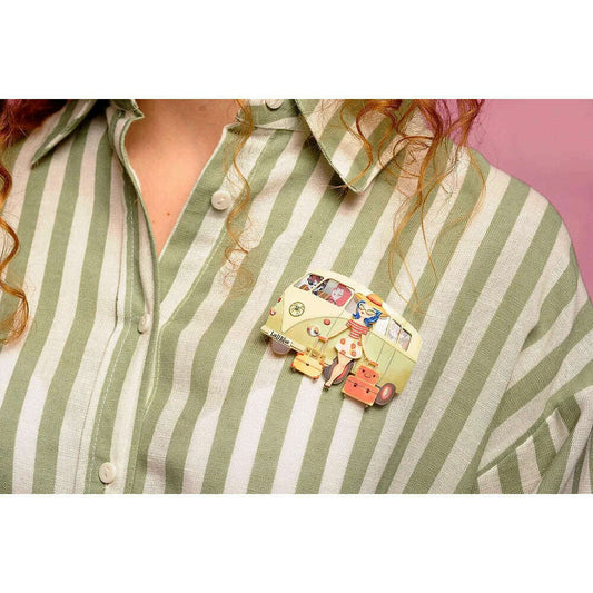 Vintage van brooch pinned to green-and-white striped shirt