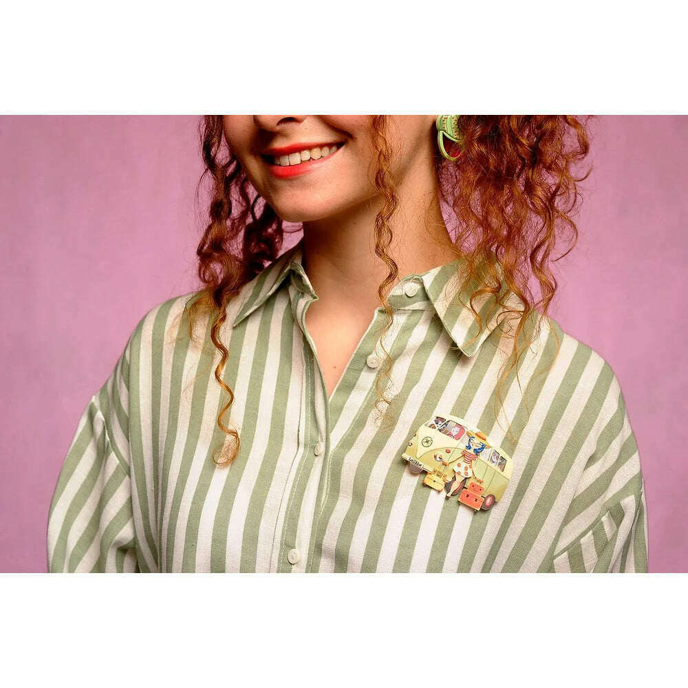 Vintage van brooch on green-and-white striped blouse