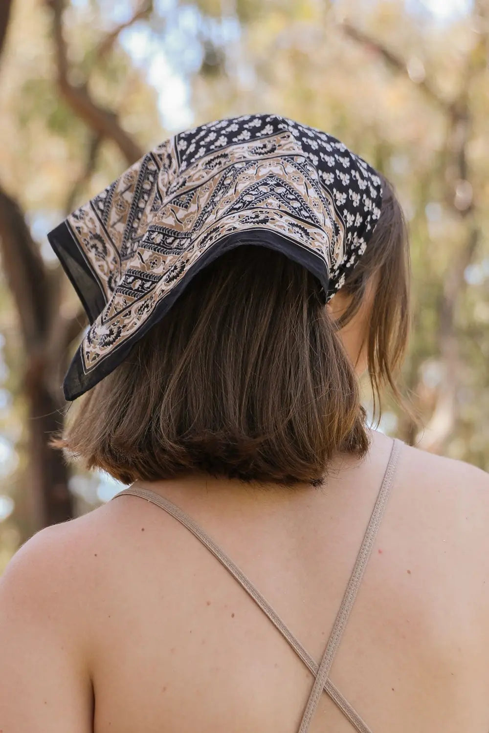 Vine motif bandana scarf, black with cream paisley and geometric border, tied in hair