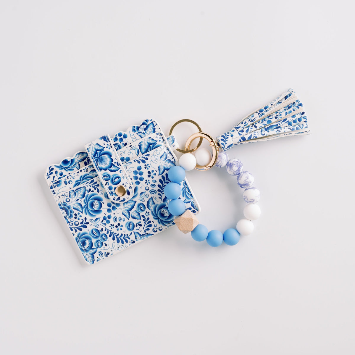 Blue patterned wallet wristlet keychain with tassel and beaded ring.