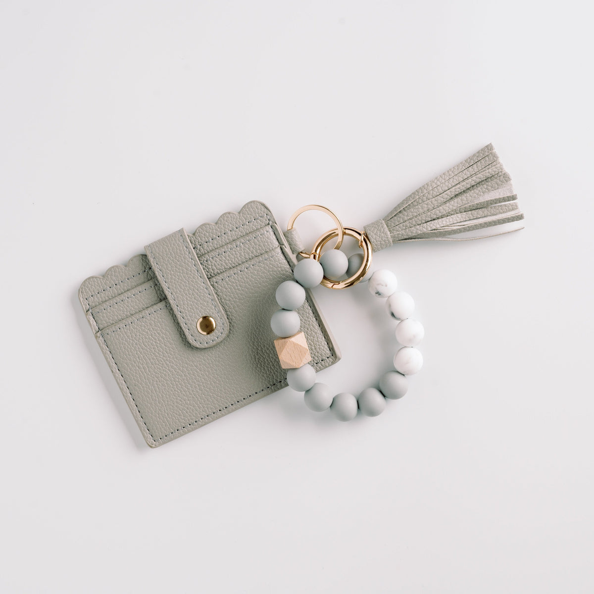 Gray wallet wristlet keychain with tassel, beaded loop strap, and gold key ring