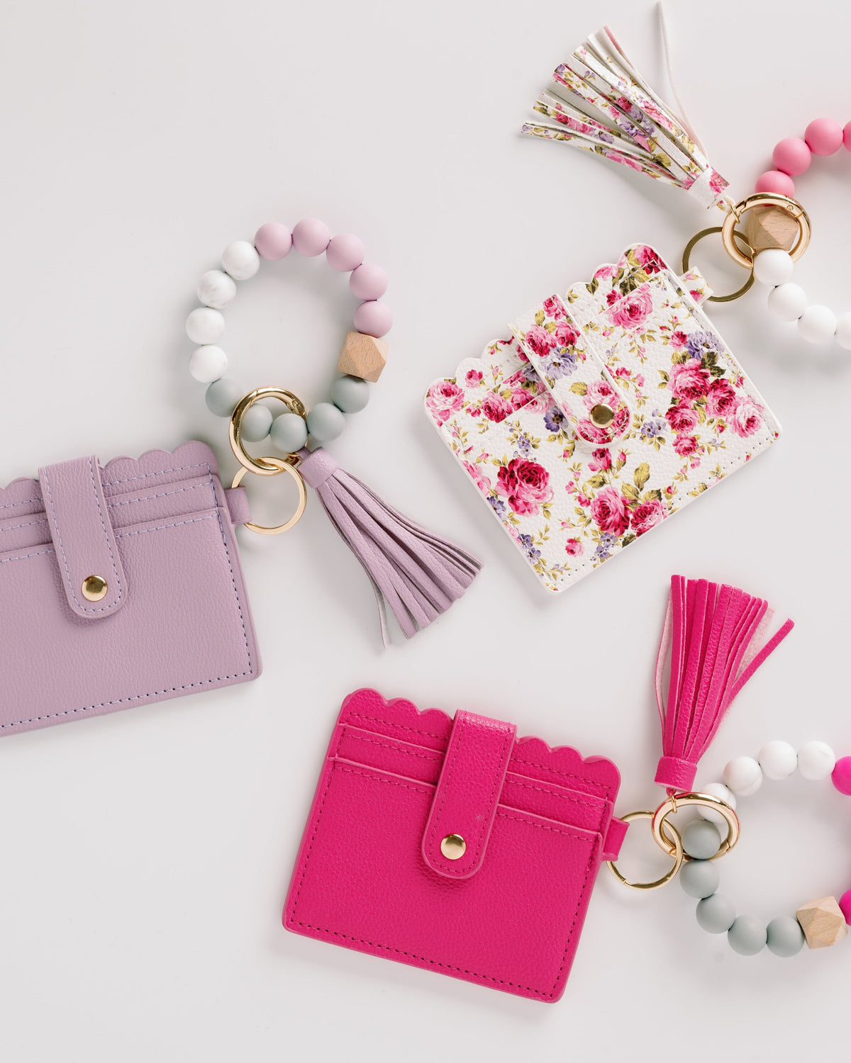 Lavender, floral, and hot pink wallet wristlet keychains with tassels and beaded keyrings