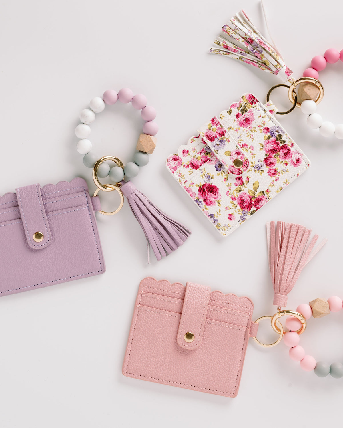 Lavender, floral, and pink wallet wristlet keychains with tassels and beaded keyrings
