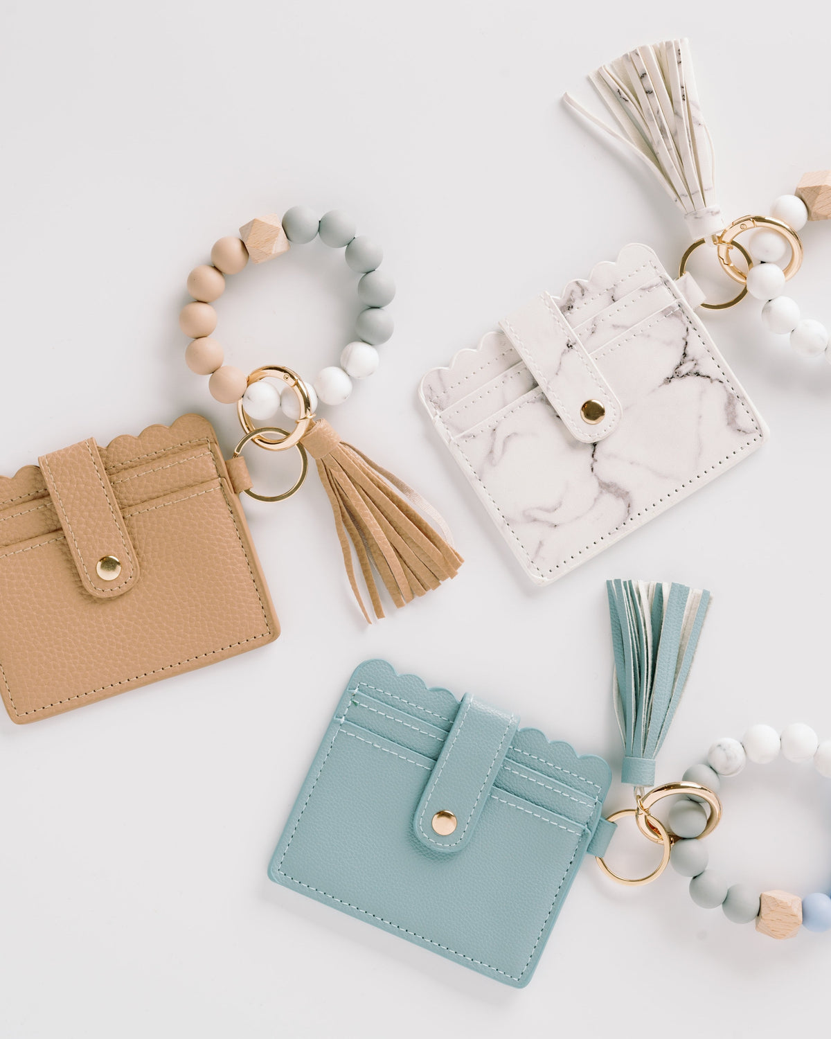 Tan, white marble, and light blue wallet wristlet keychains with tassels and beaded keyrings
