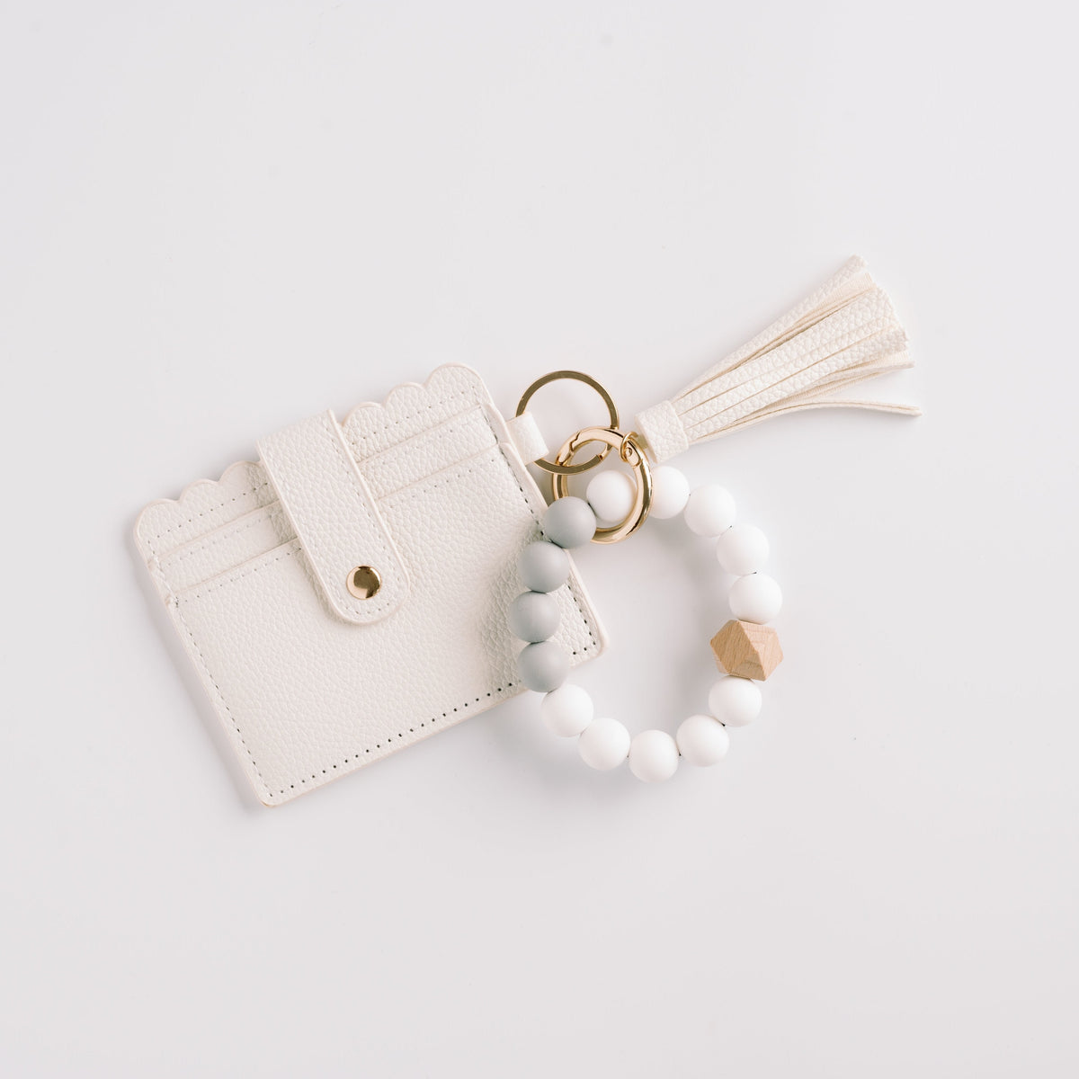 White wallet wristlet keychain with cream tassel and beaded keyring charm.