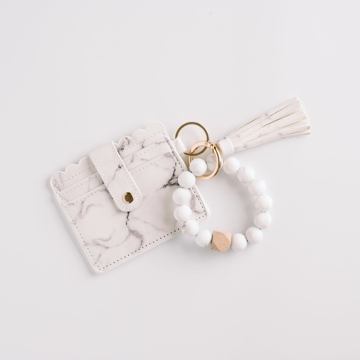 White marble wallet wristlet keychain with tassel, beaded strap, and gold key ring