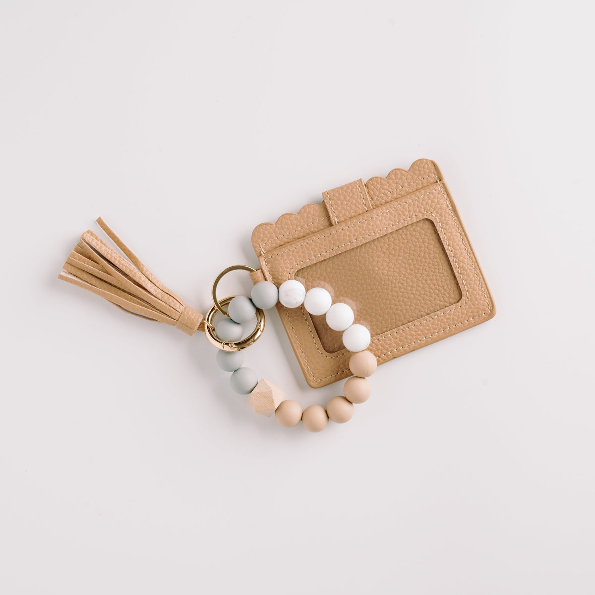 Light tan wallet wristlet keychain with tassel, beaded strap, and gold key ring