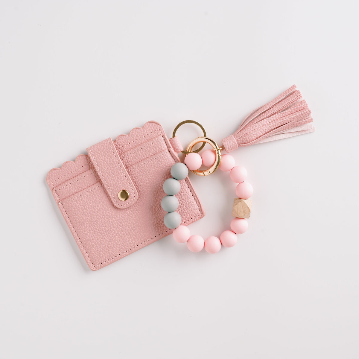 Pink wallet wristlet keychain with tassel, beaded strap, and gold key ring