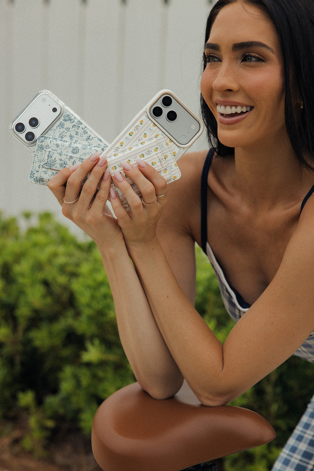 Floral magnetic phone wallet held with other printed magnetic wallet cases