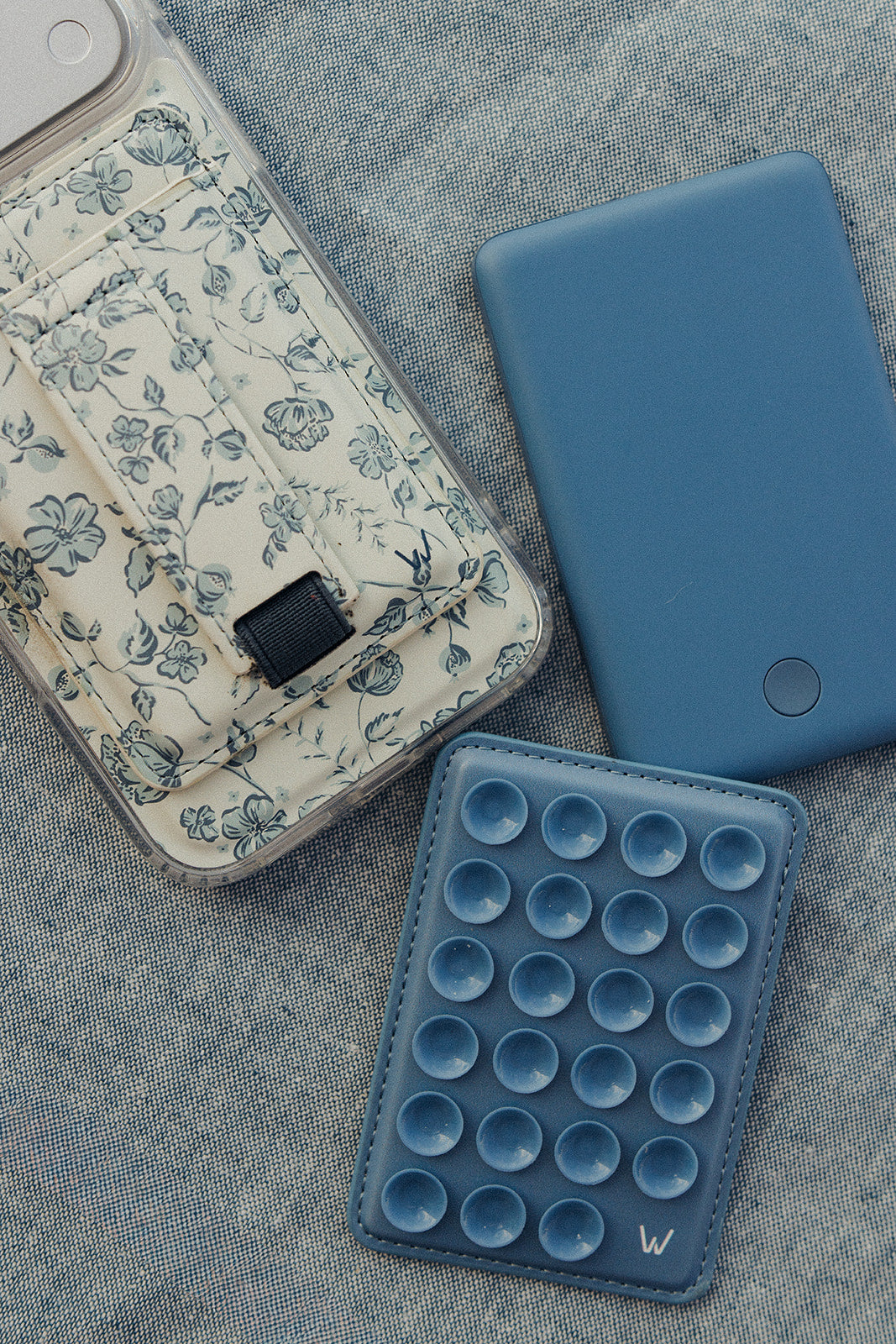 Floral magnetic phone wallet next to blue pop-style magnetic wallet