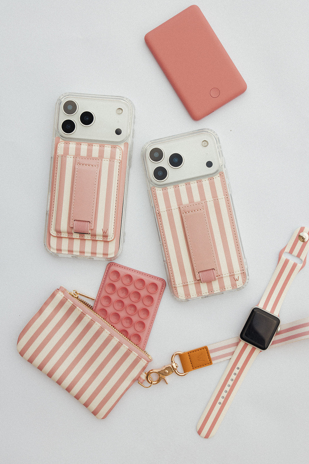 Assorted pink striped and solid zippered pouches with wrist straps