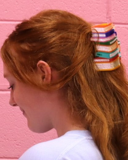 Book stack hair claw on blonde ponytail with stacked colorful mini books