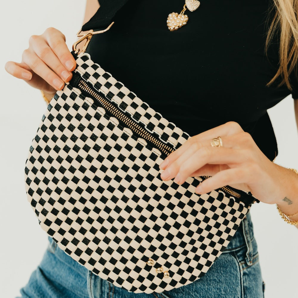 Black-and-white checkered woven bum bag with gold zipper and zip pull