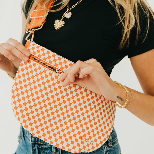 Orange and white woven checkered bum bag with zipper and adjustable crossbody strap.