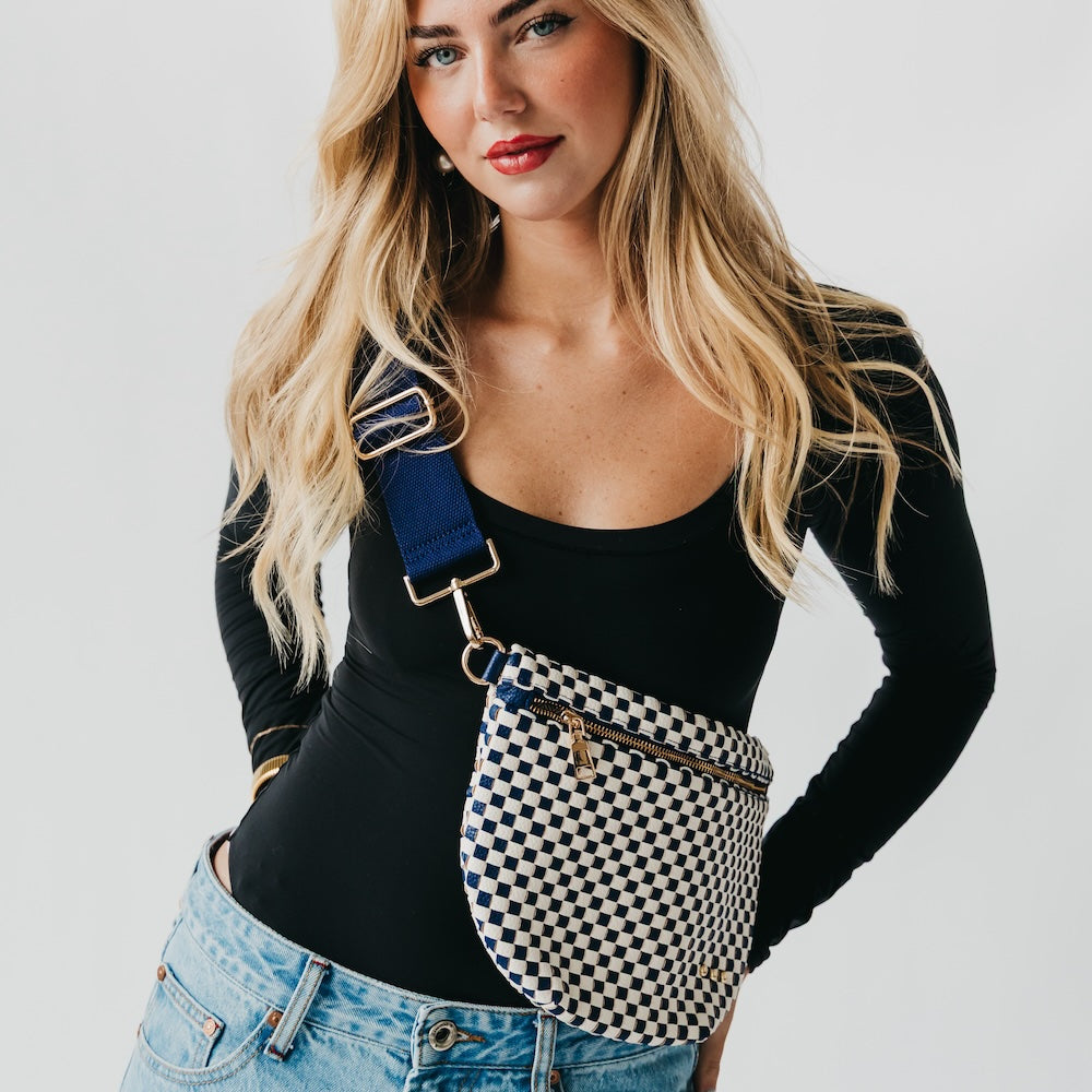 Woven bum bag with black-and-white check pattern, gold buckle strap, front zip pocket.