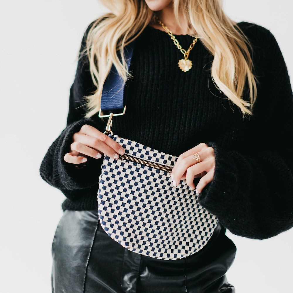 Woven bum bag with black-and-white check fabric and gold-tone zip, crossbody strap.