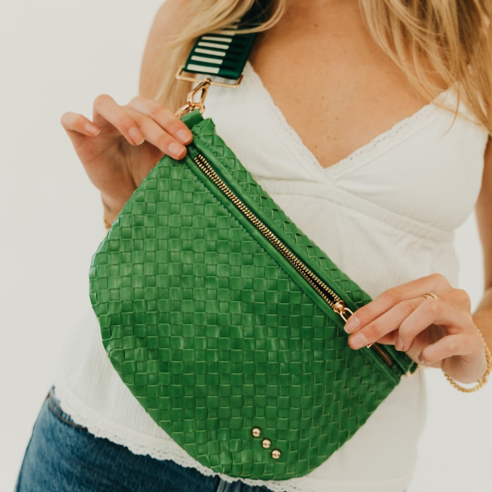 Green woven bum bag with zipper closure and adjustable crossbody strap.