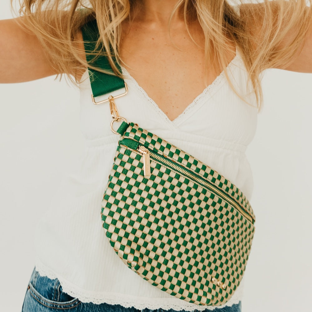 Green and white woven checkered bum bag with zipper top and adjustable crossbody strap.