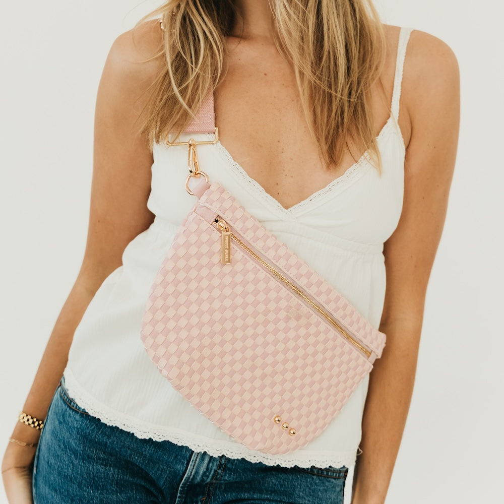 Westlyn woven bum bag in blush pink checker pattern, gold zipper and strap hardware