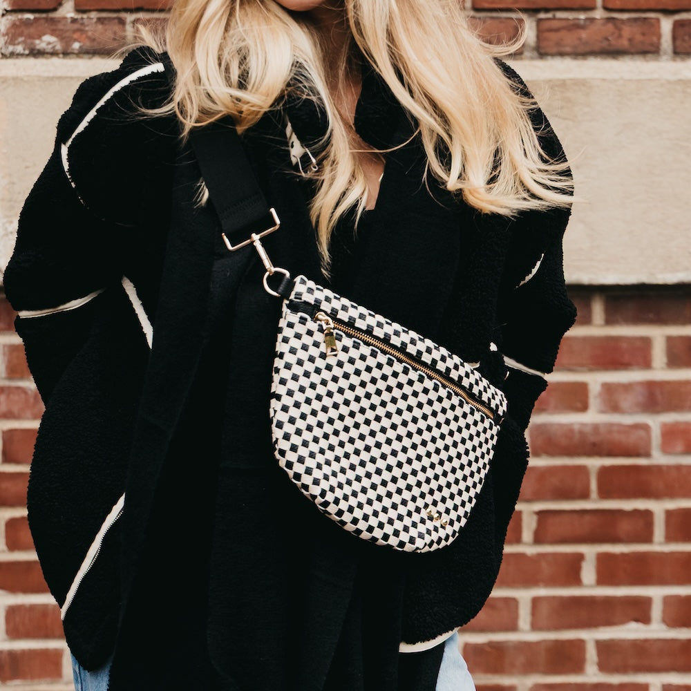 Black-and-white checkered woven bum bag with front zipper and adjustable strap