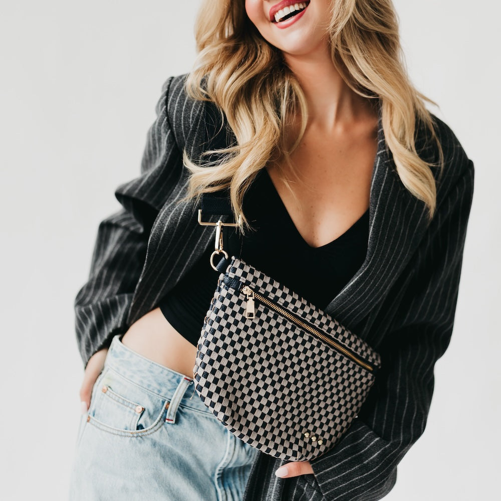 Westlyn woven bum bag in black-and-white checker pattern with gold zipper pull